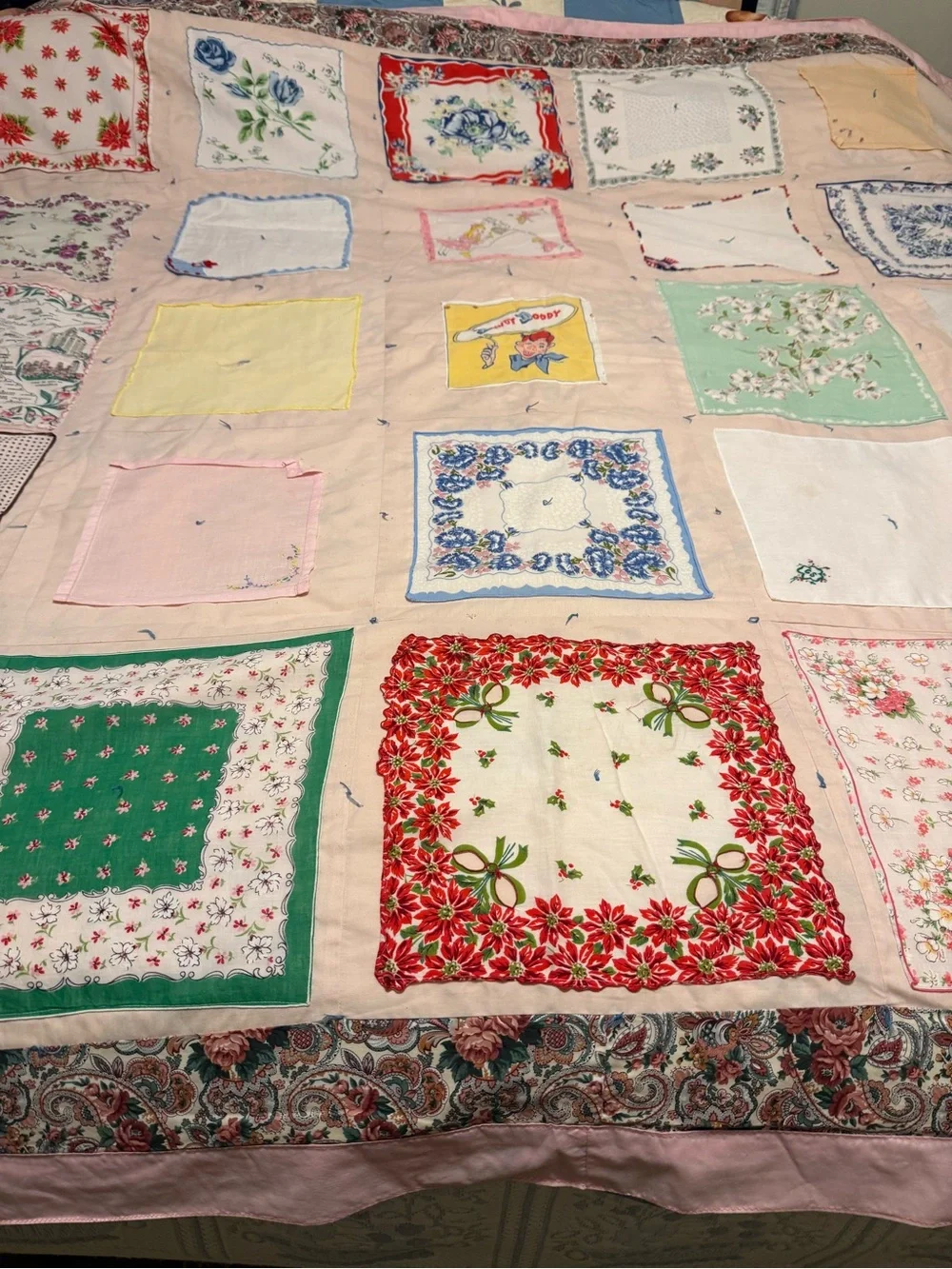 vintage handkerchief quilt featuring a variety of floral patterns